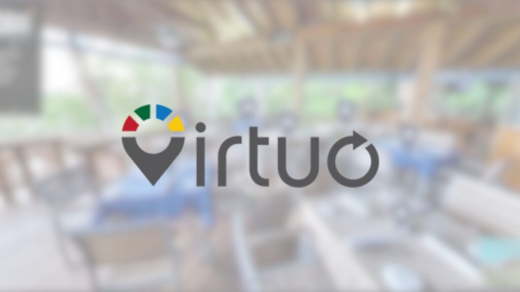 A blurred indoor setting with a logo featuring a colorful circular design and the text "Virtuo" with an arrow, centered on the image.